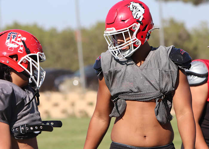 Teammates literally and figuratively look up to 6-foot-5, 260-pound Paki Fanau (right). Photo: John Murphy